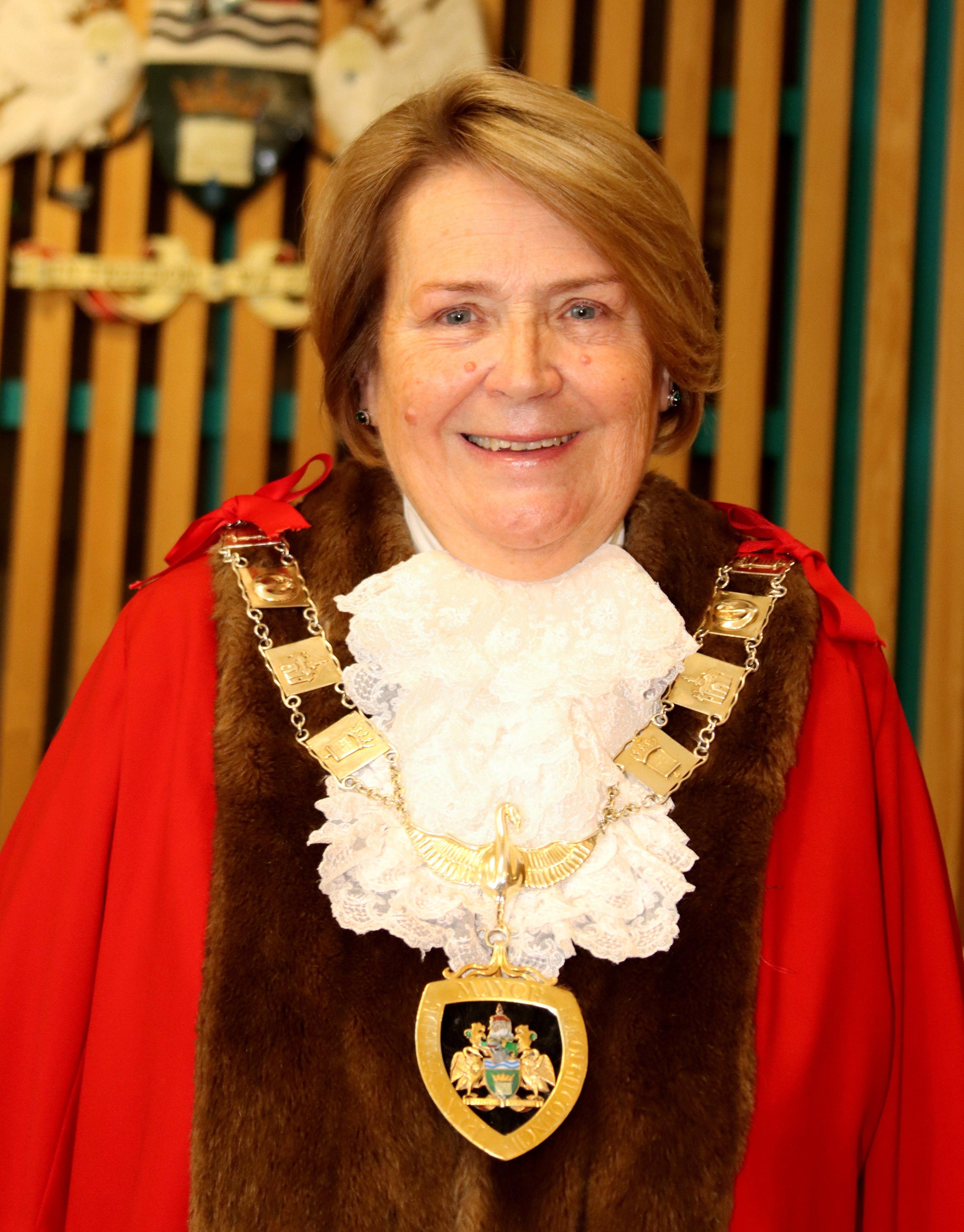 A lady wearing robes for a Mayor