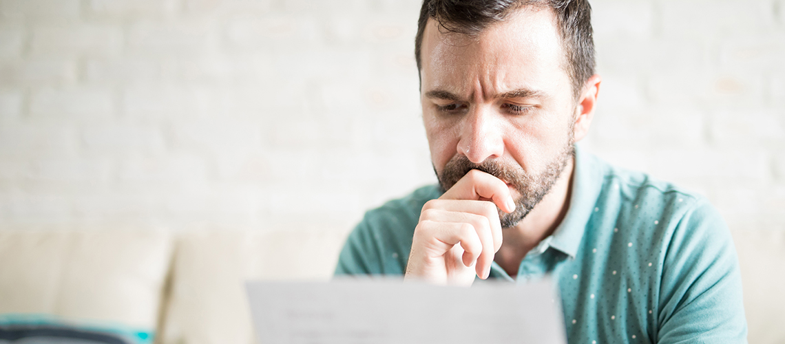 Concerned person looking at letter