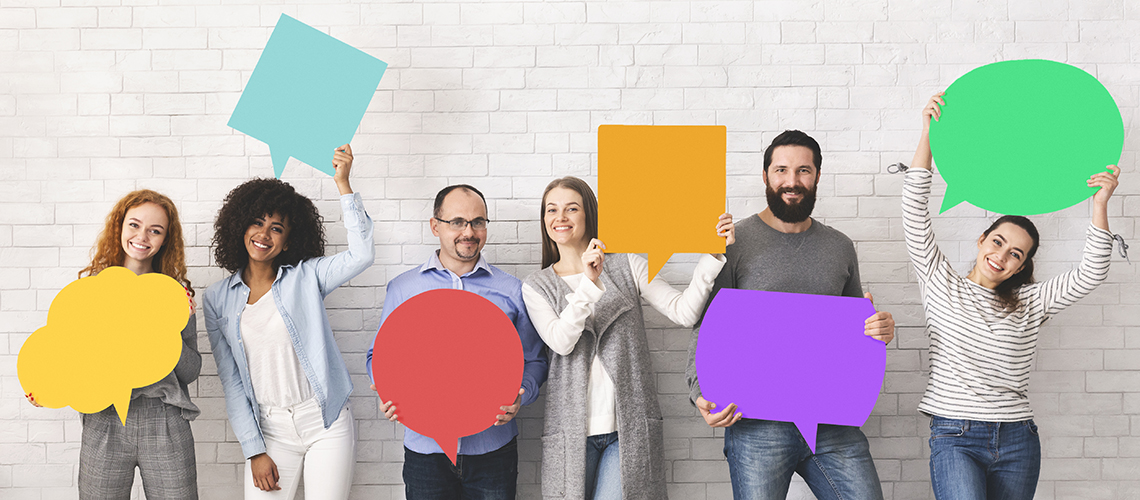 Group of people holding feedback signs