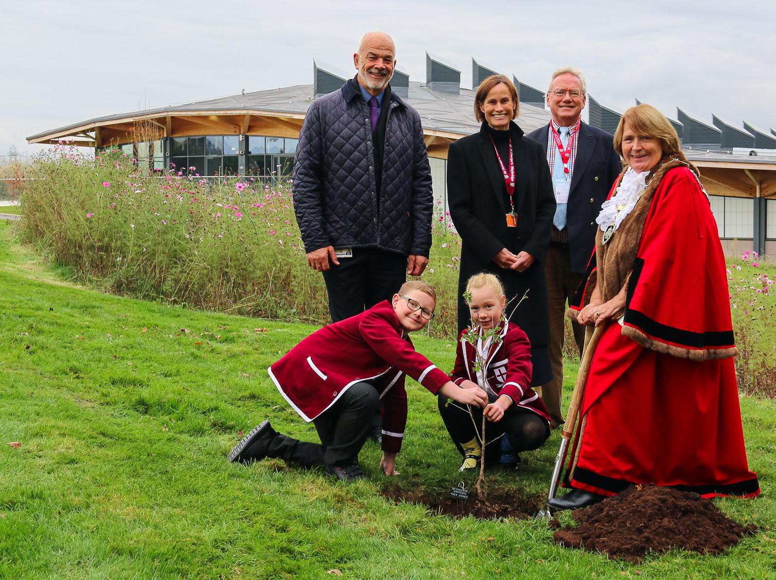 The Mayor of Runnymede, Cllr Elaine Gill plants a tree at St. George's College Weybridge