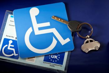 Blue badge card with car key.