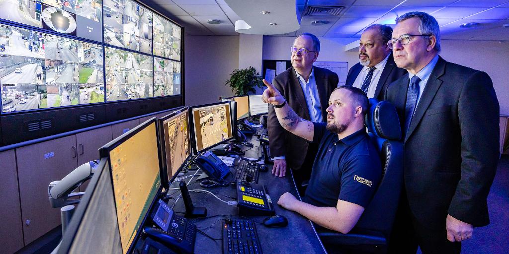 Cllr Bailey (Hart), Cllr Howorth (Runnymede) and Cllr Sheehan (Rushmoor) being shown the CCTV monitoring screens by Control Centre Operator Ed Smith