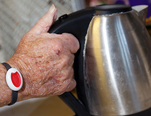 Person wearing a community alarm on their wrist