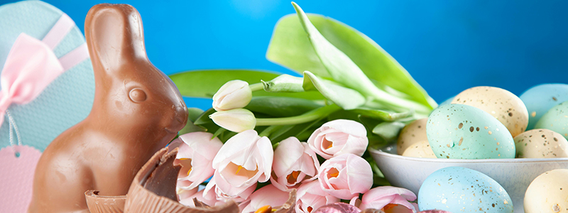 Easter eggs, chocolate bunny and Easter flowers