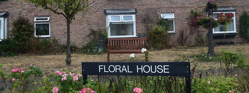 Outside Floral House including house sign and gardens