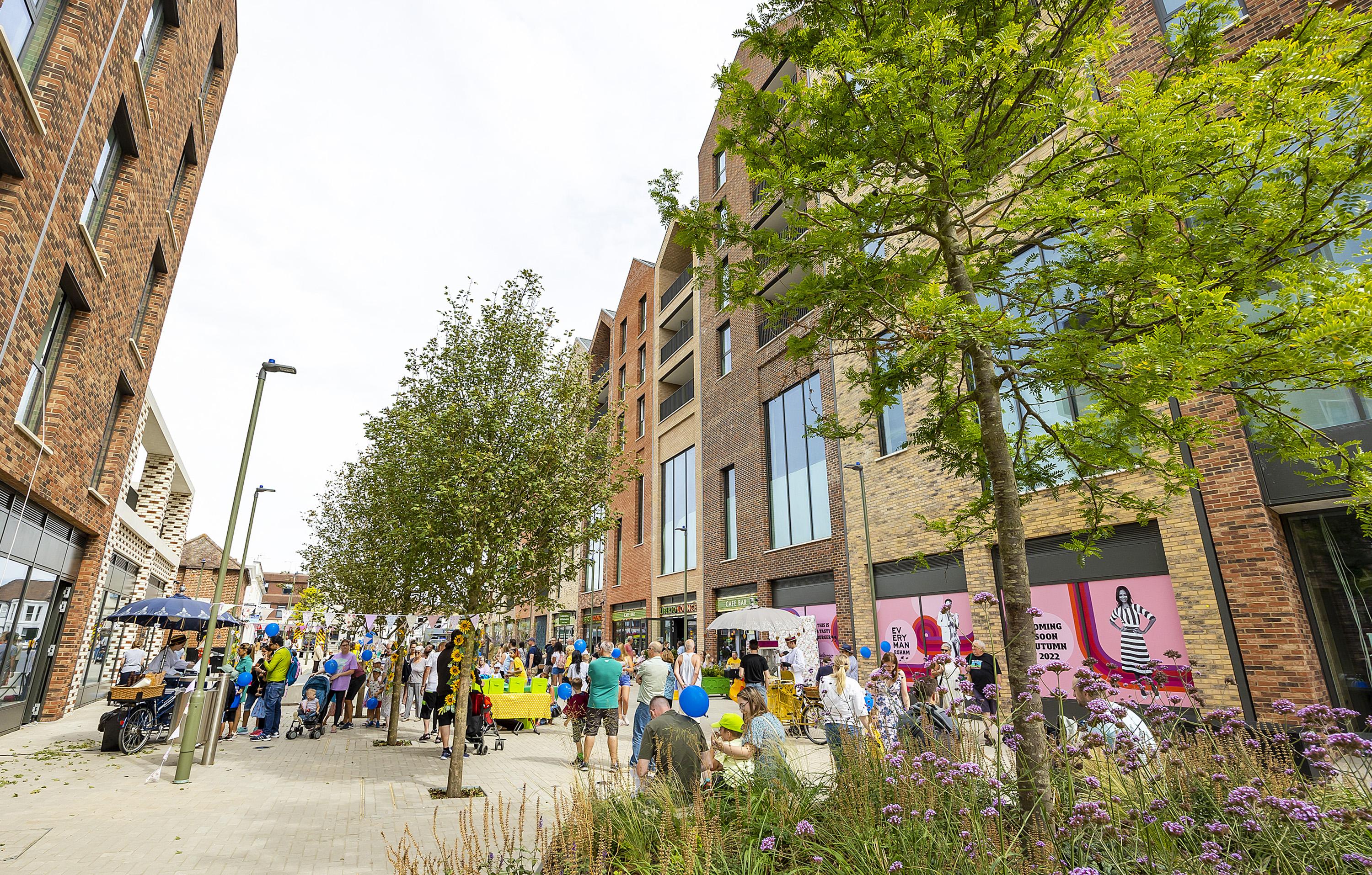 An image showing the public square at Magna Square with members of the public gathered at an event