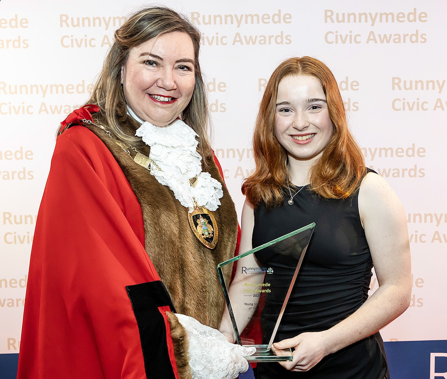 A young woman receives an award.