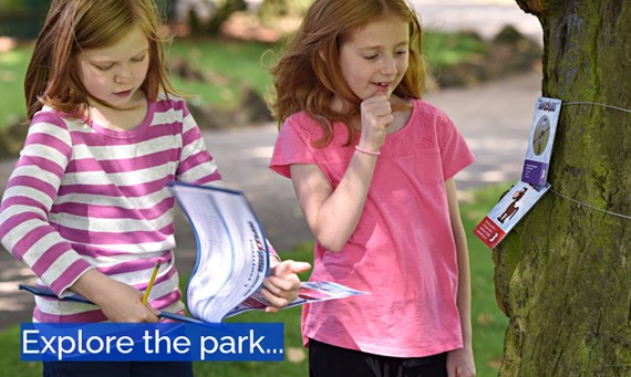 Children looking at a marker in the park