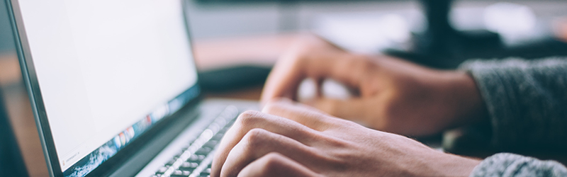 Hands using computer keyboard