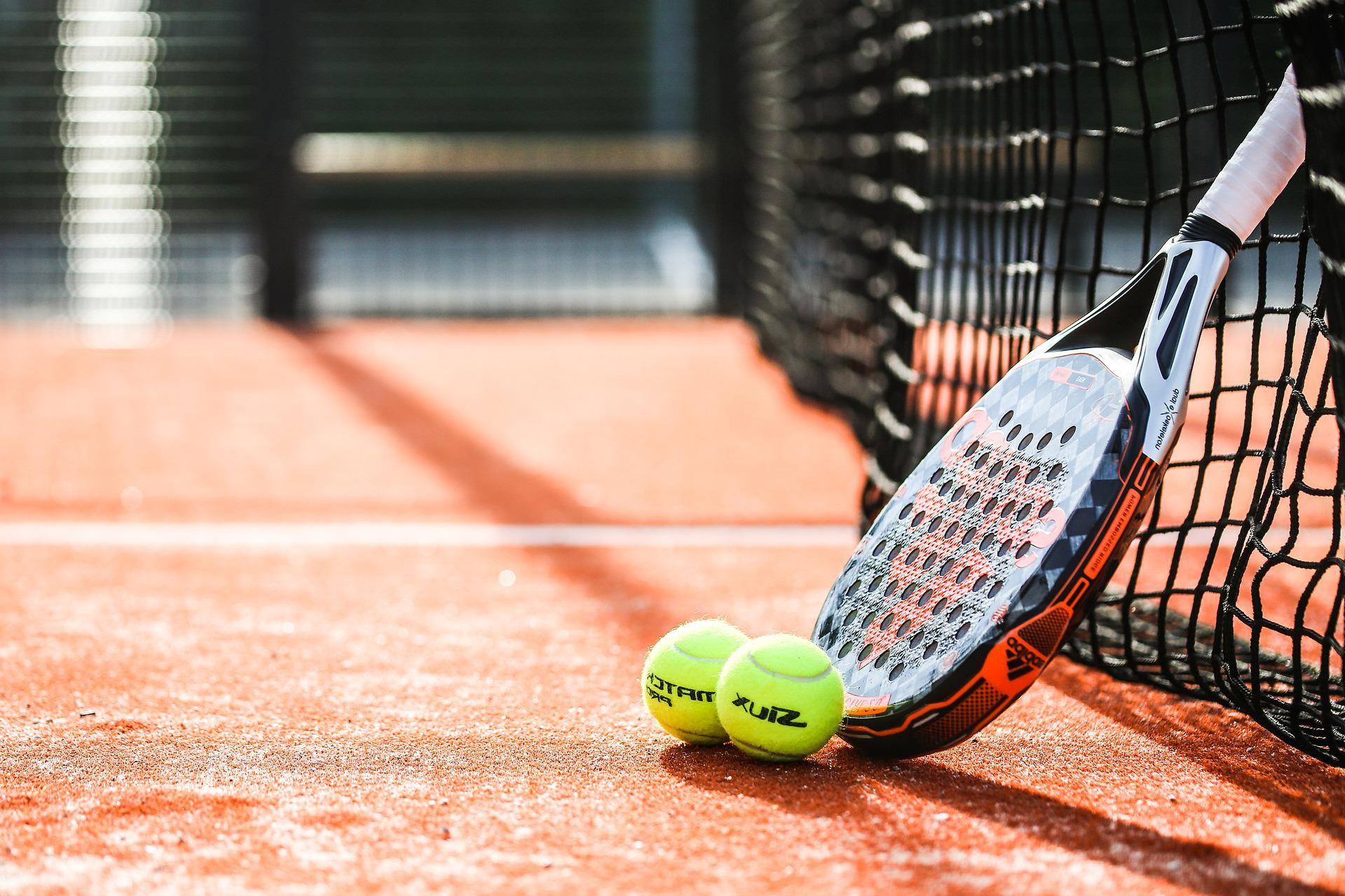 a tennis racket leaning against the net